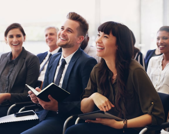 Smiling professionals attending a real estate training session