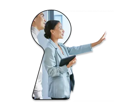 Female real estate agent showing home to client, viewed through a keyhole-shaped graphic frame