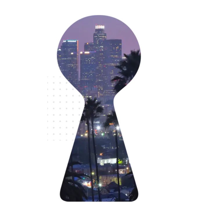Los Angeles skyline seen through keyhole design at dusk with palm trees and city lights